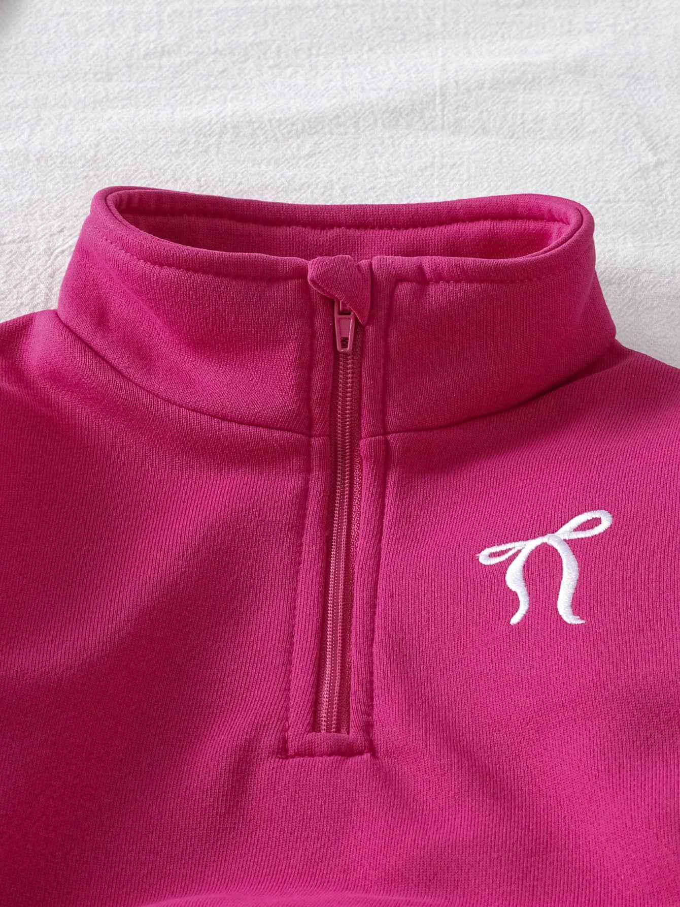 Prenda fucsia conjunto para bebe detalle de cuello alto y media cremallera