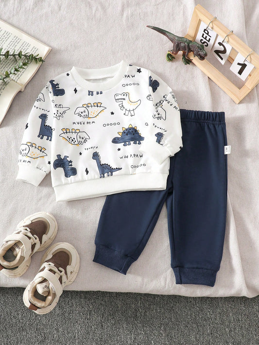 Prenda blanca conjunto para bebe con estampado de dinosaurios y pantalón azul marino vista frontal