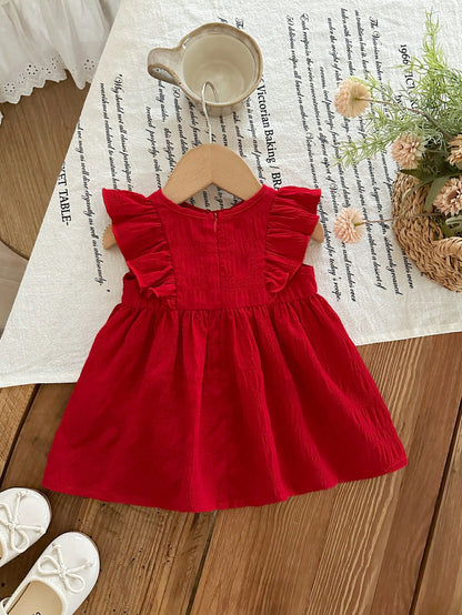 Prenda rojo vestido para bebe con volantes y lazo vista trasera
