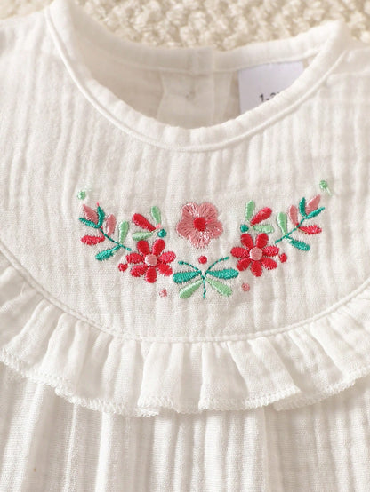 Prenda blanca vestido para bebe detalle de bordado floral