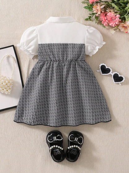 Prenda blanco y negro vestido para bebe vista trasera con falda a cuadros