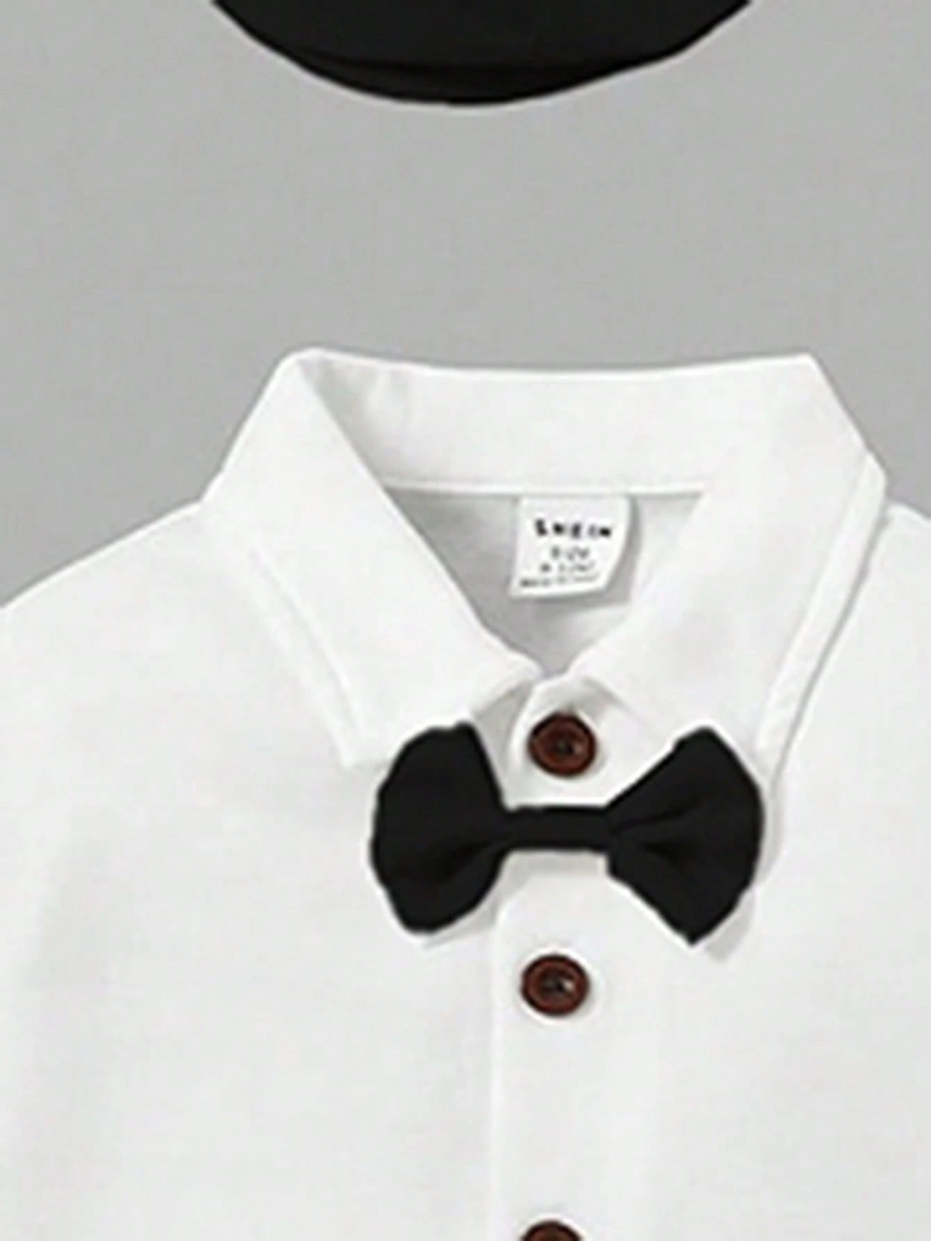 Prenda blanco negro conjunto para bebe detalle de moño y botones
