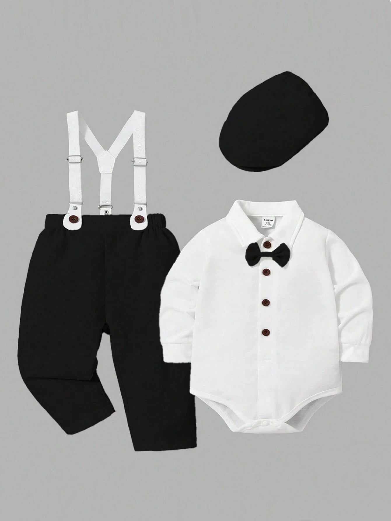 Prenda blanco negro conjunto para bebe formal con tirantes vista frontal
