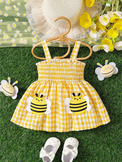 Prenda amarilla vestido para bebe a cuadros con abejas vista frontal