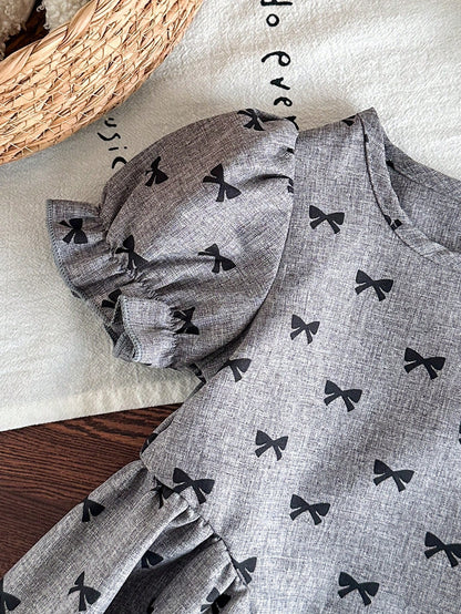 Prenda gris vestido para bebe detalle de manga abullonada y estampado de lazos