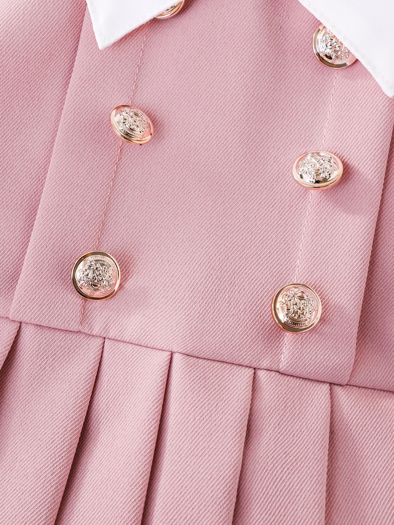 Prenda rosa vestido para bebe con detalle de botones dorados y falda plisada
