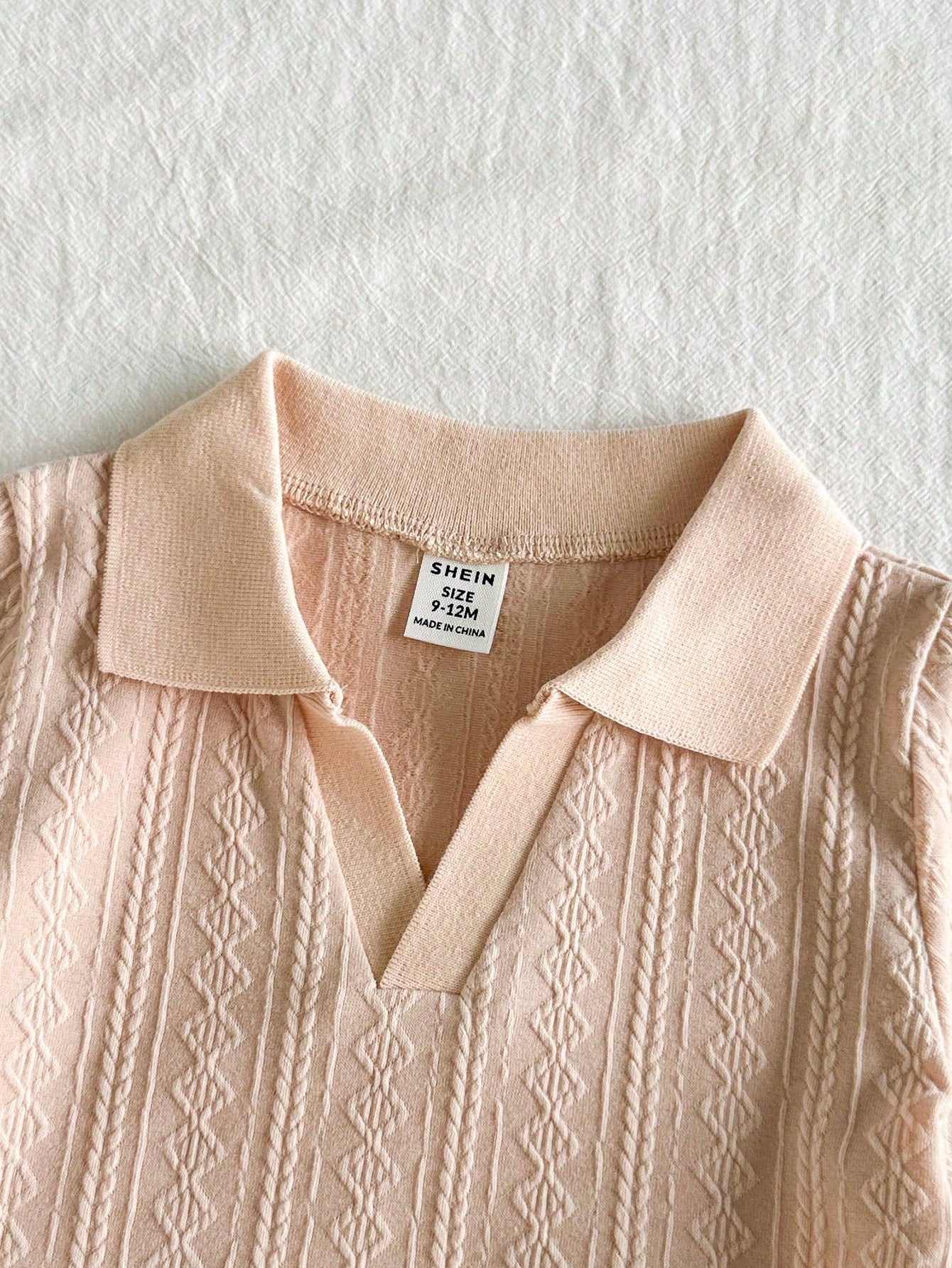 Prenda albaricoque conjunto para bebe detalle del cuello polo texturizado