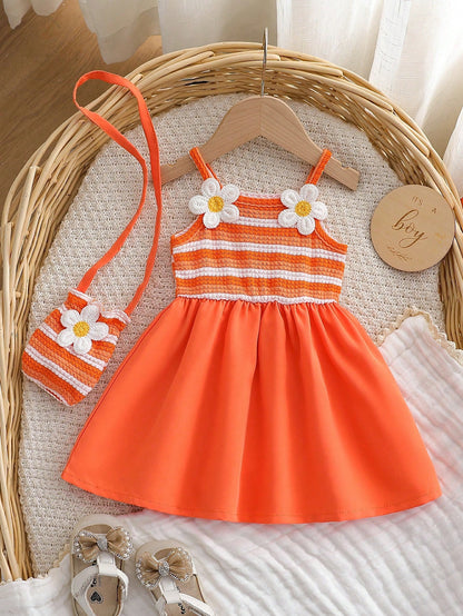 Prenda naranja conjunto para bebe con vestido y bolso a juego vista frontal