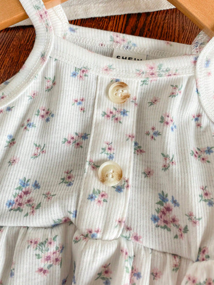 Prenda blanca conjunto para bebe con detalle de botones y estampado floral