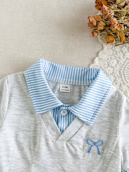 Prenda gris vestido para bebe con detalle de cuello polo y lazo bordado