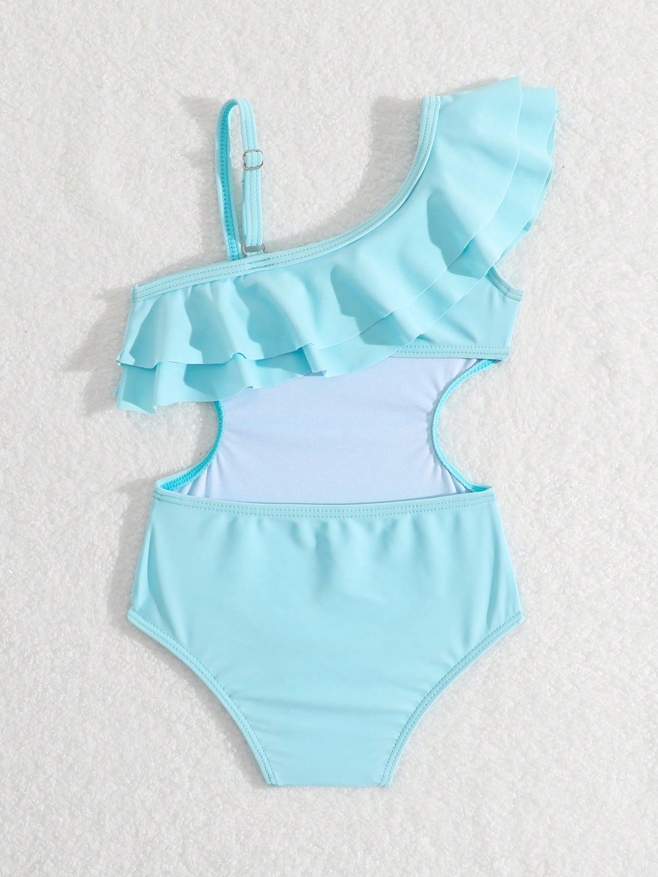 Prenda celeste traje de baño para bebe con aberturas laterales vista trasera