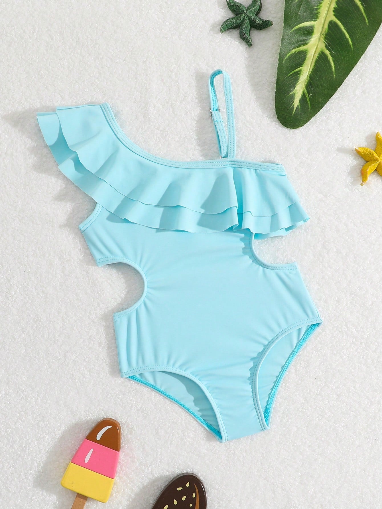 Prenda celeste traje de baño para bebe con volantes asimétricos vista frontal