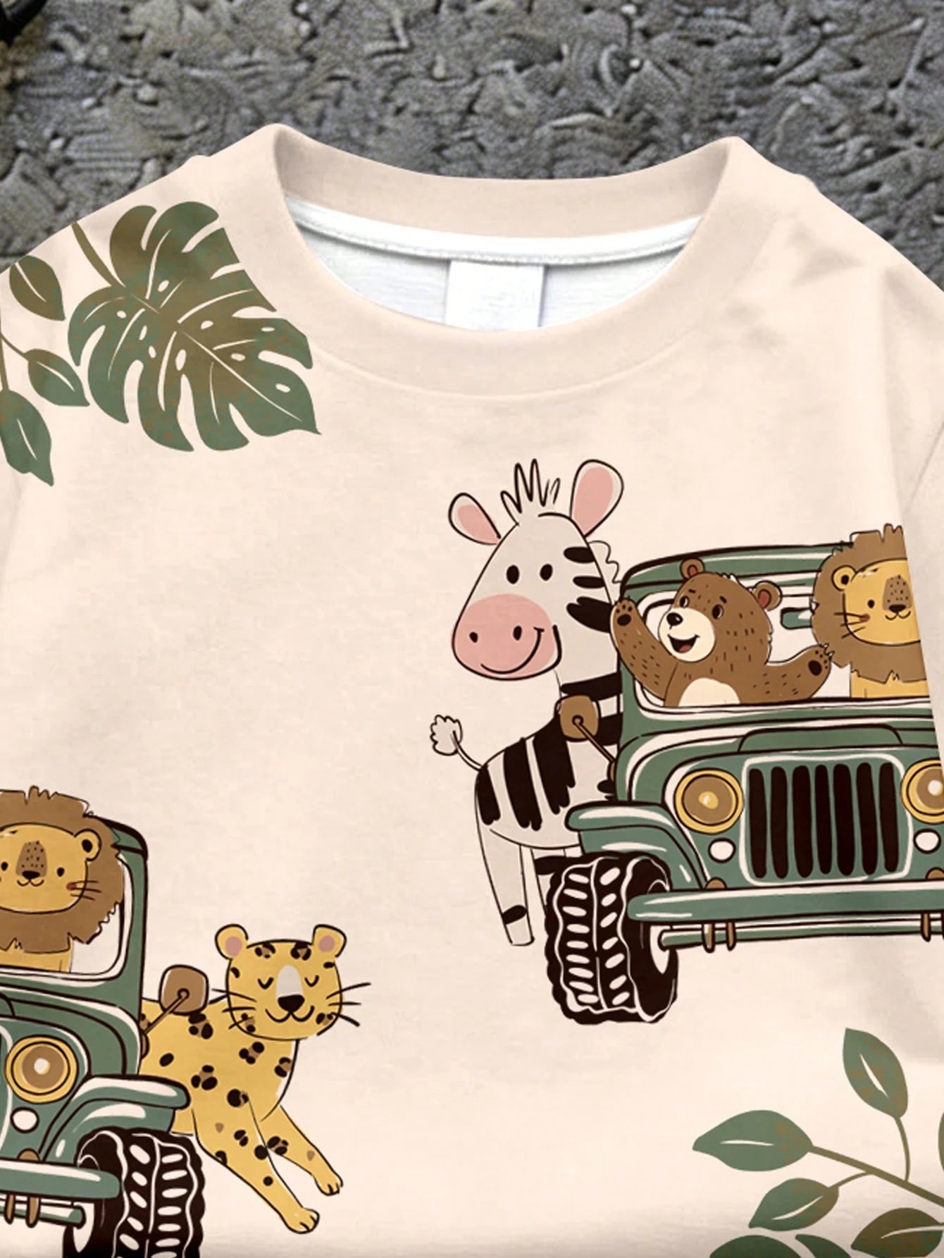 Prenda beige camiseta para bebe con animales y vehículo safari detalle frontal