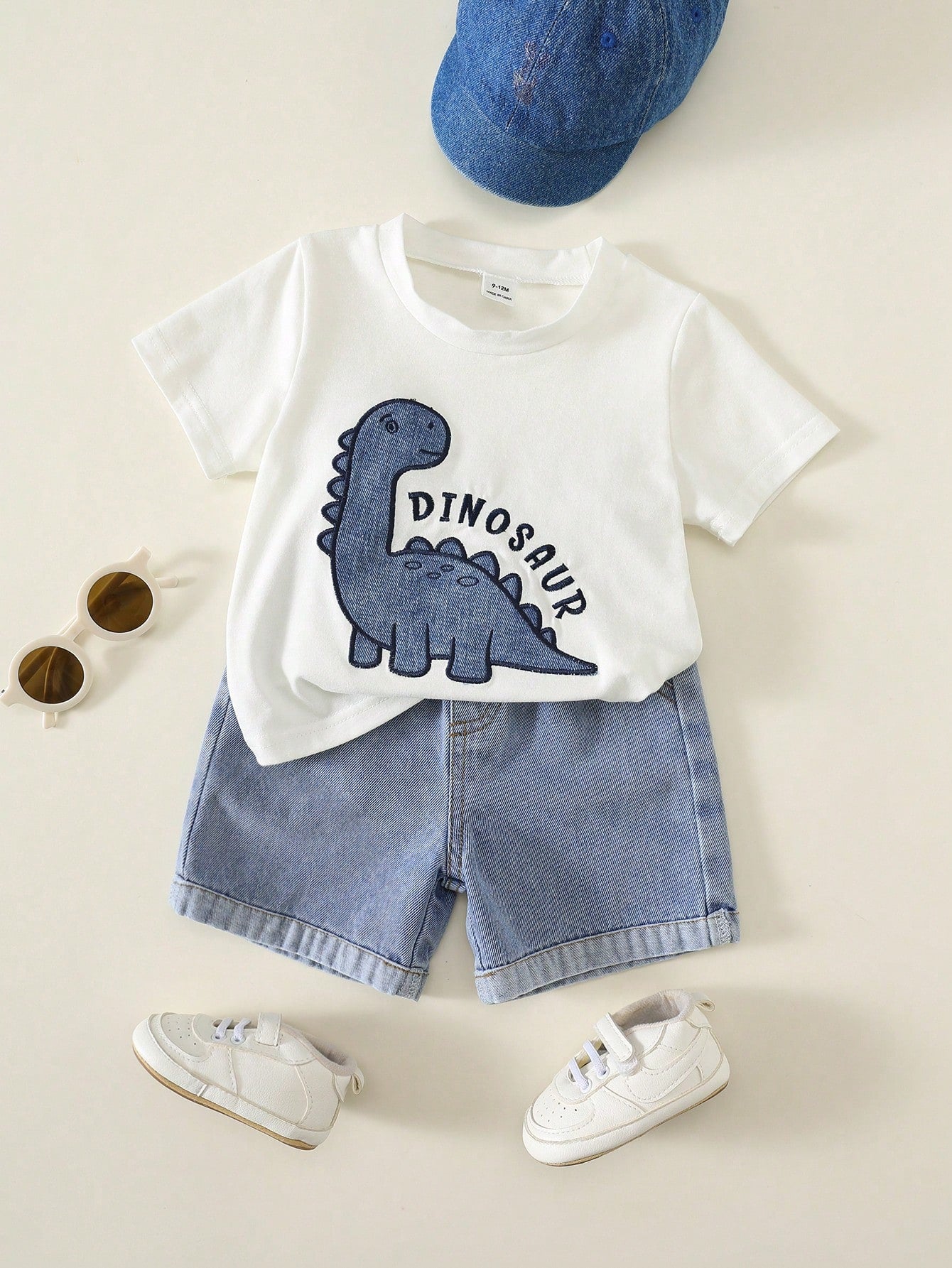 Prenda blanca conjunto para bebe con dinosaurio bordado y shorts de mezclilla vista frontal