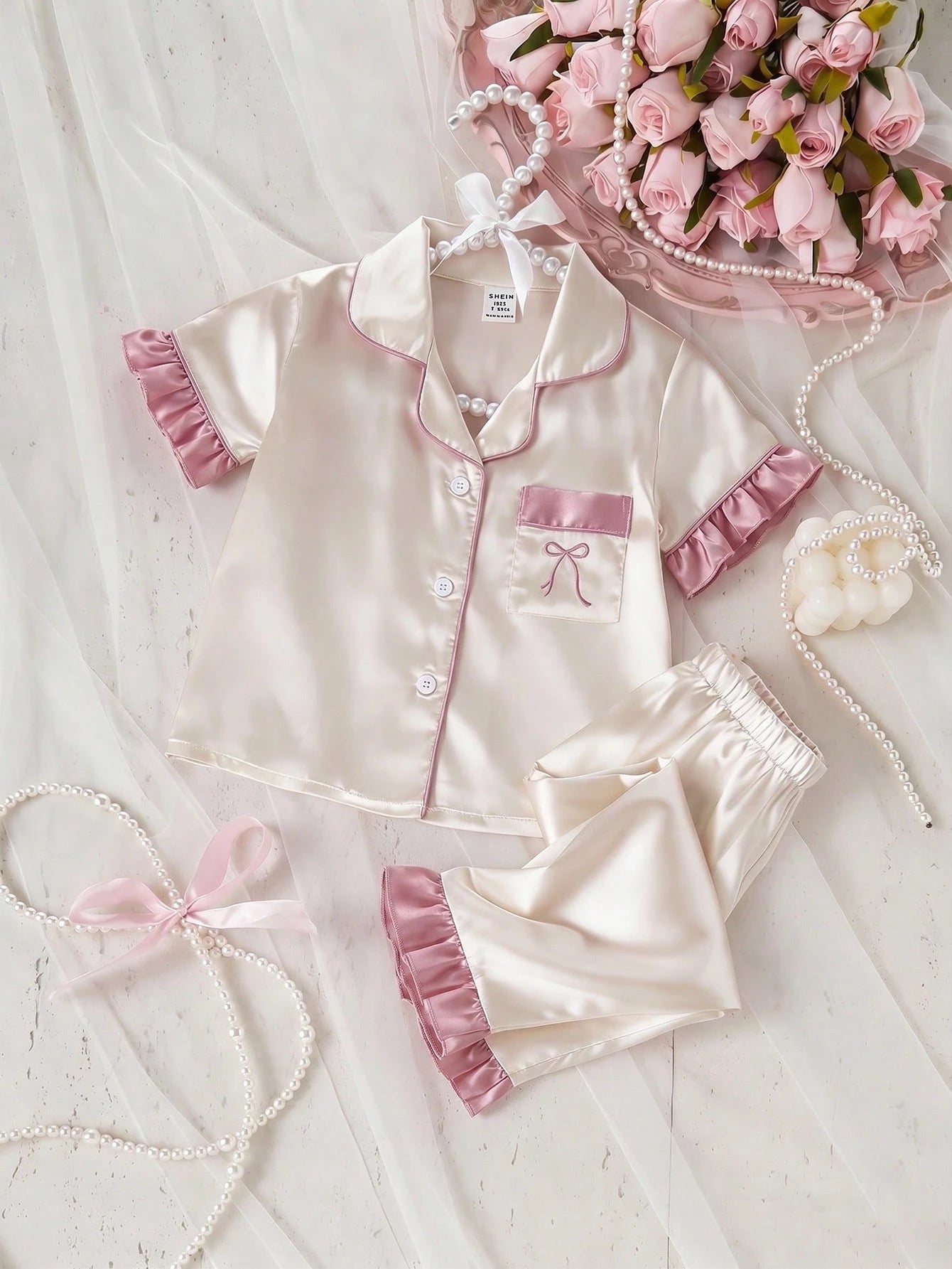 Prenda champán pijama para bebe con lazo bordado y volantes vista frontal