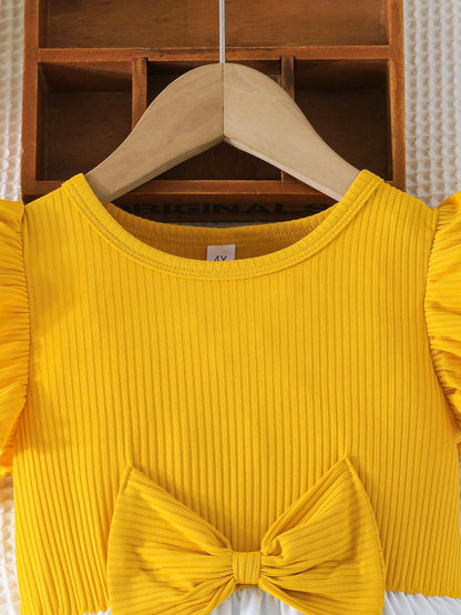 Prenda amarilla vestido para bebe detalle de lazo delantero
