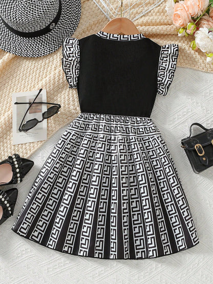 Prenda blanco y negro vestido para bebe con estampado geométrico vista trasera