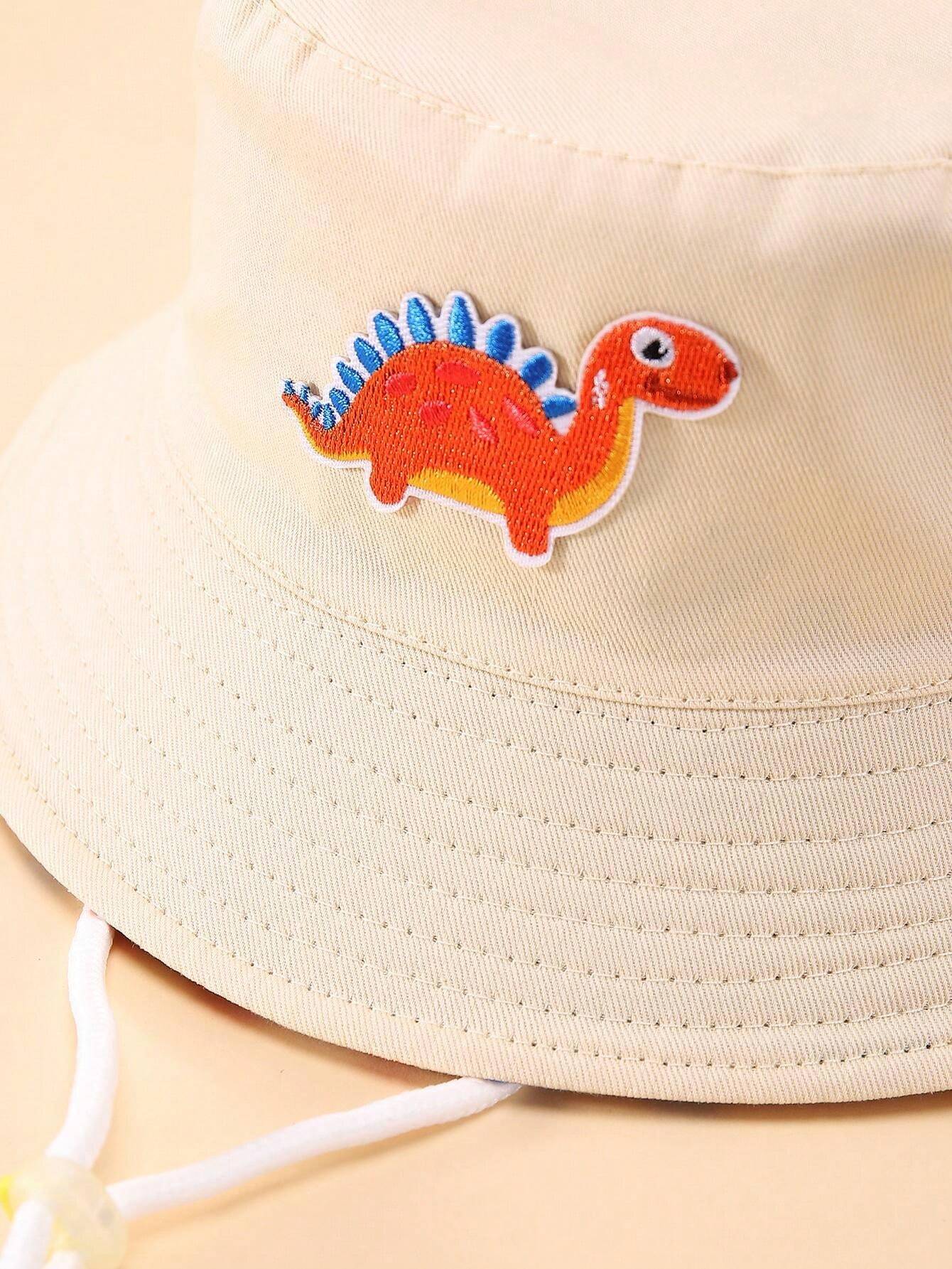 Prenda beige sombrero cubo para bebe con detalle de dinosaurio bordado