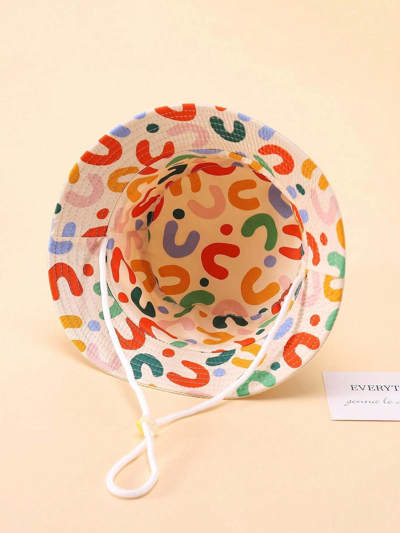 Prenda beige sombrero cubo para bebe reversible con estampado multicolor vista interior