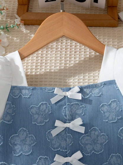 Prenda azul vestido para bebe detalle de lazos frontales y escote cuadrado