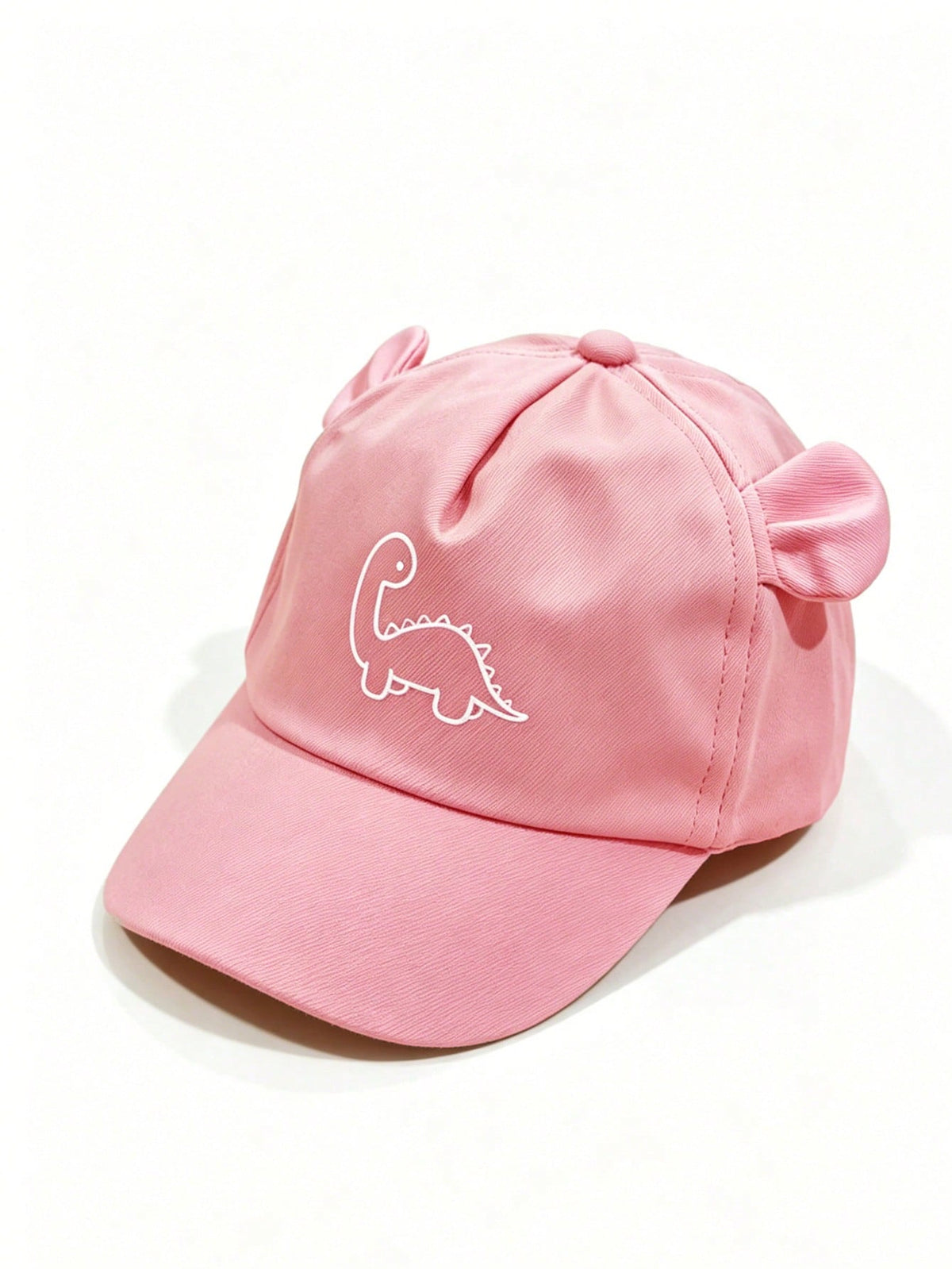 Prenda rosa gorra para bebe con dinosaurio y orejitas vista frontal
