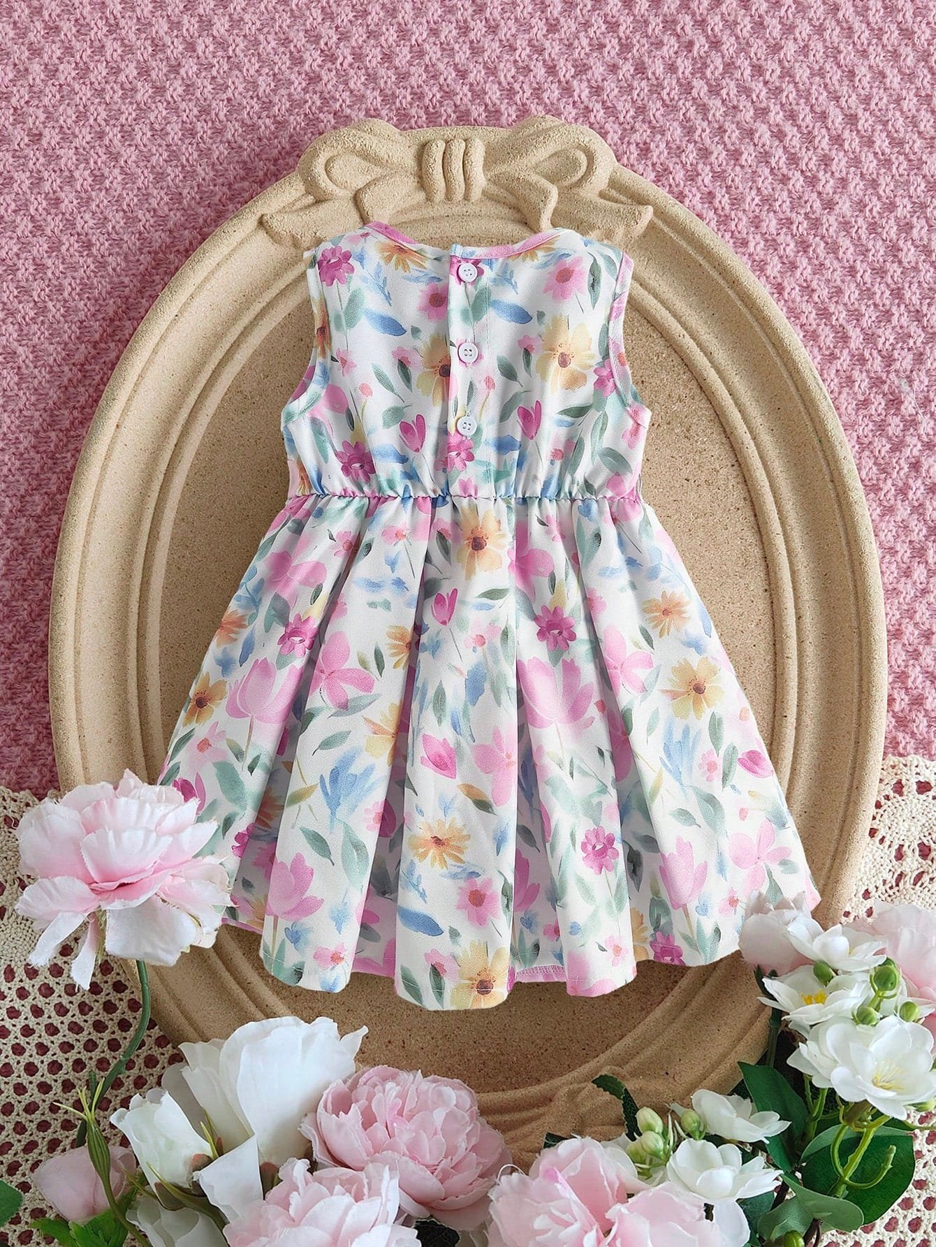 Vestido floral rosa sin mangas con moño para bebé