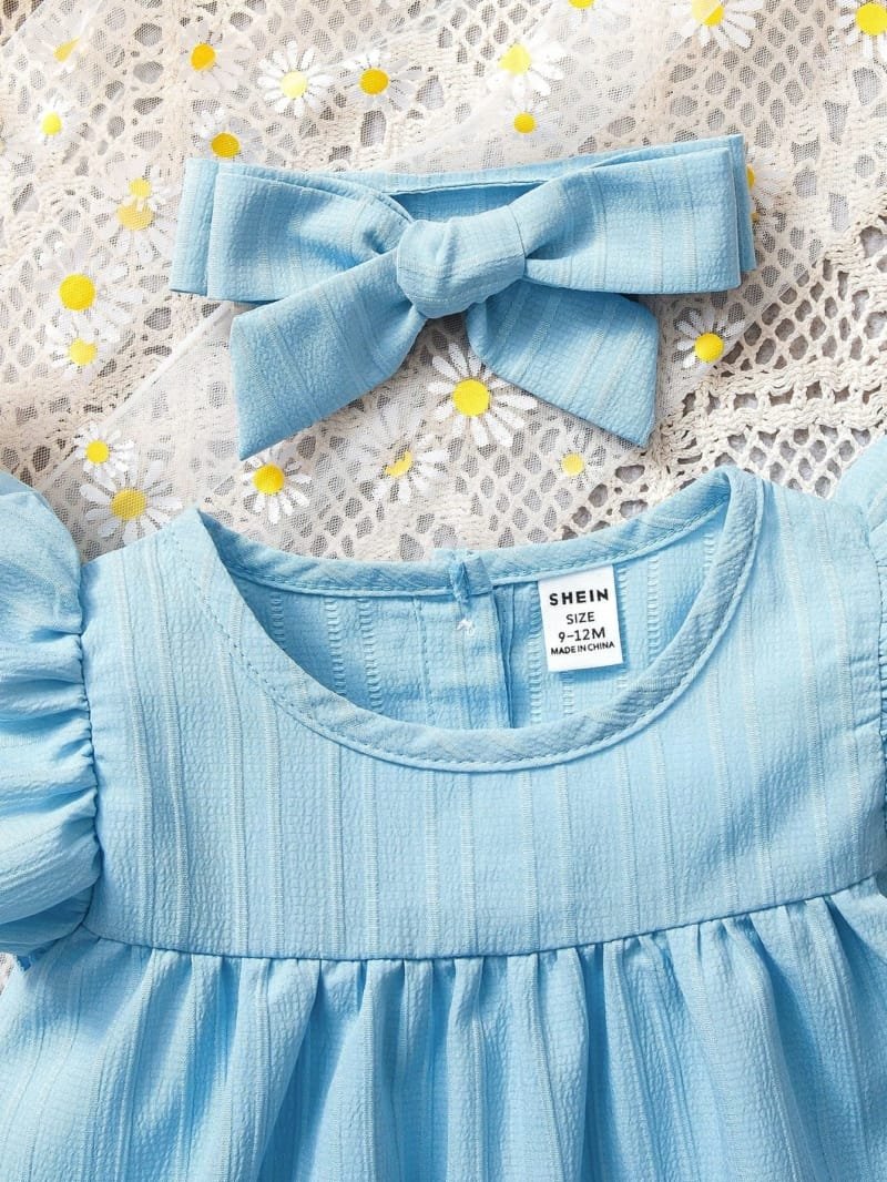 Vestido azul liso con diadema de moña