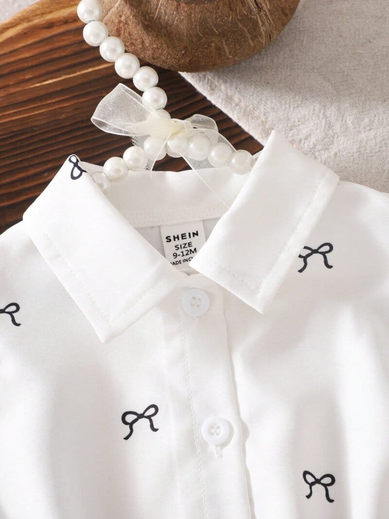Conjunto blanco y negro con falda plisada y blusa bordada