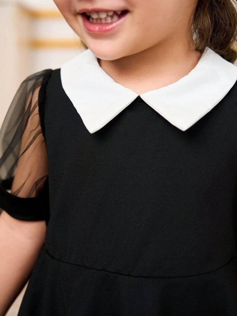 Vestido negro elegante con mangas farol y cuello blanco