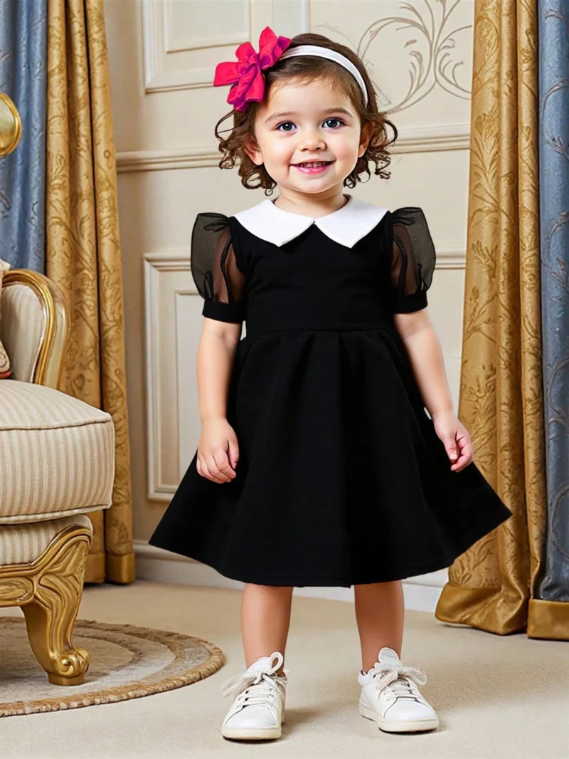 Vestido negro elegante con mangas farol y cuello blanco