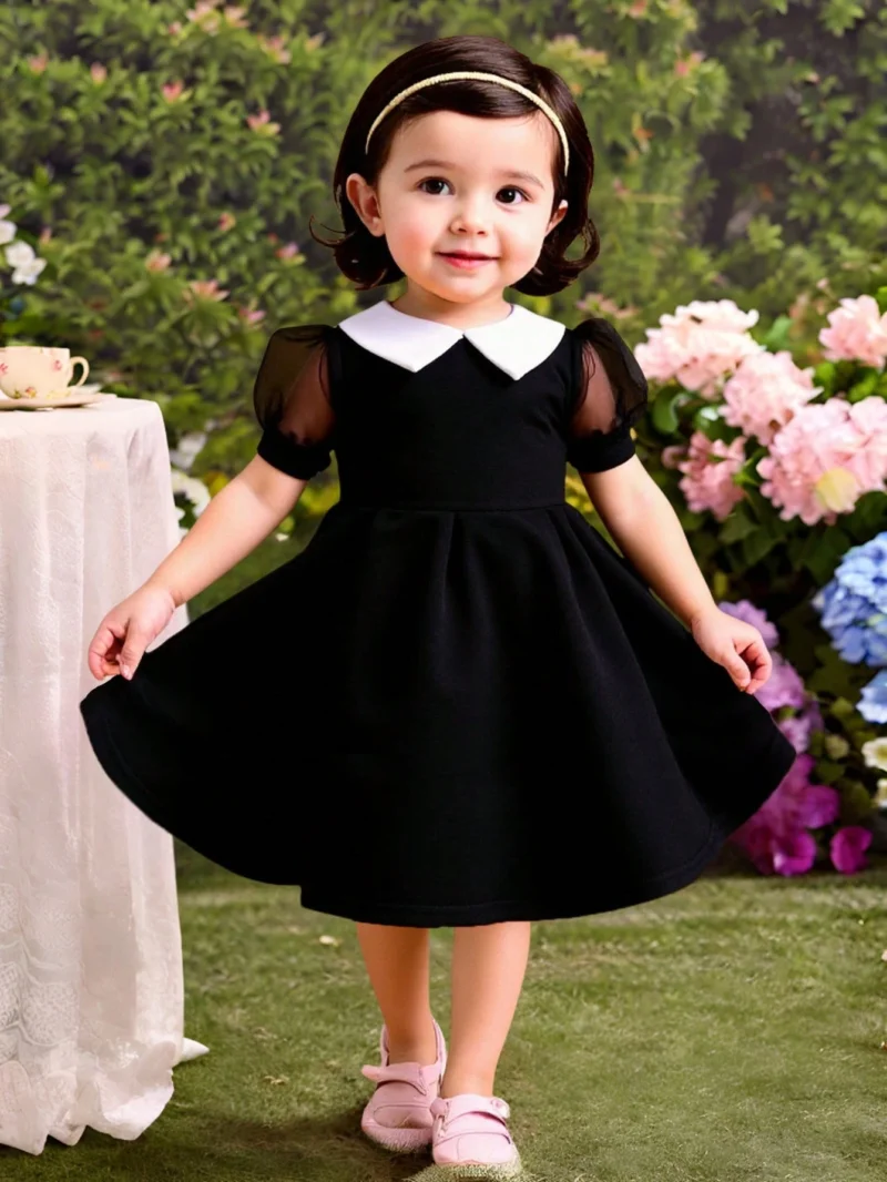 Vestido negro elegante con mangas farol y cuello blanco