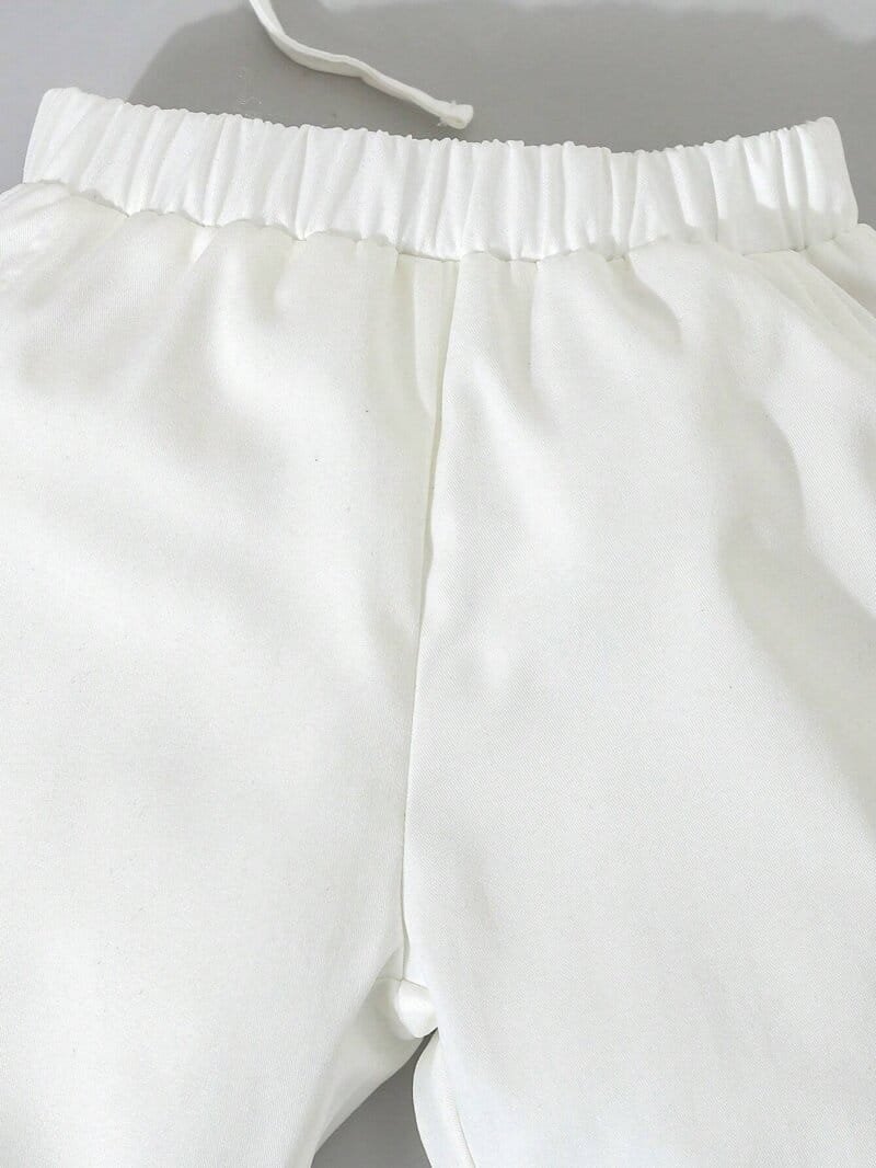 Conjunto blanco elegante para bautizo con moño