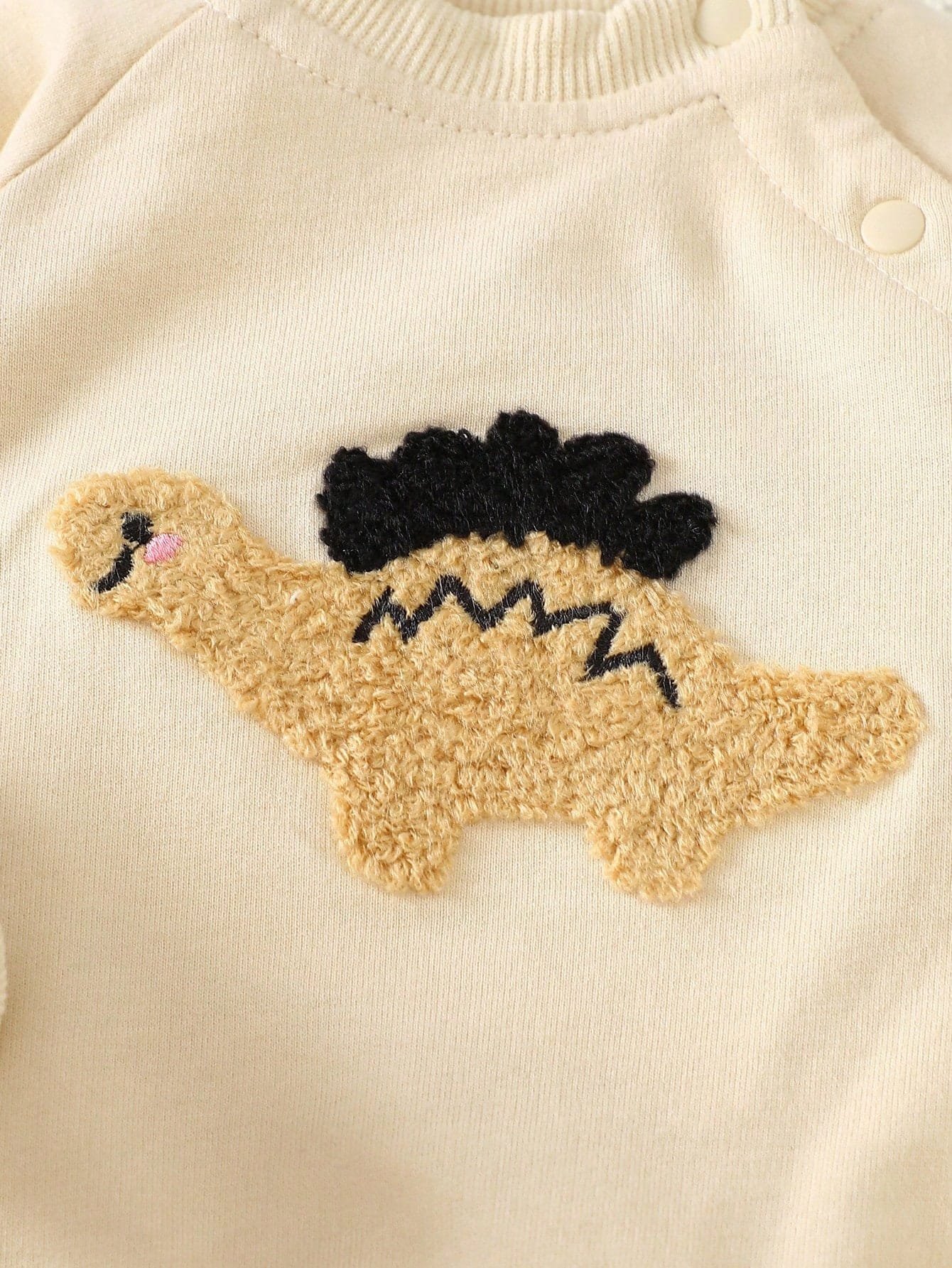 Conjunto albaricoque con sudadera dinosaurio y pantalón a rayas