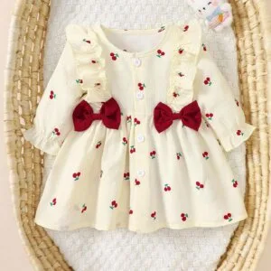 Vestido albaricoque dulce con volantes y lazos rojos