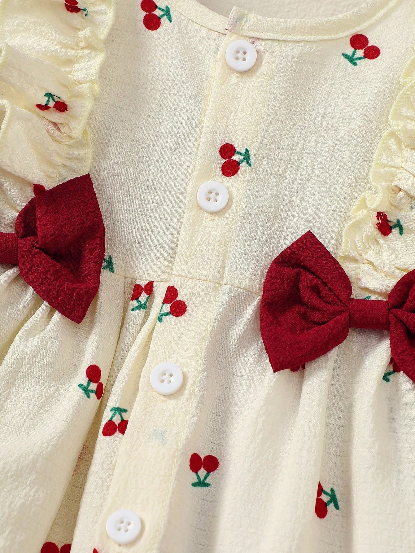 Vestido albaricoque dulce con volantes y lazos rojos